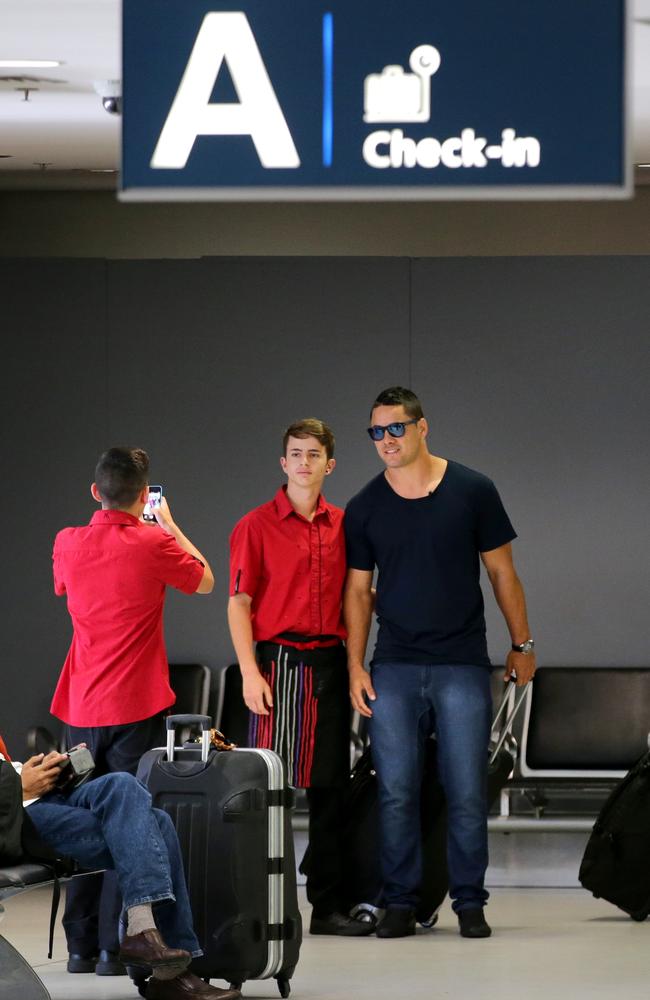 Jarryd Hayne stops with young fans at Sydney Airport before his departure from Australia. Picture: Gregg Porteous