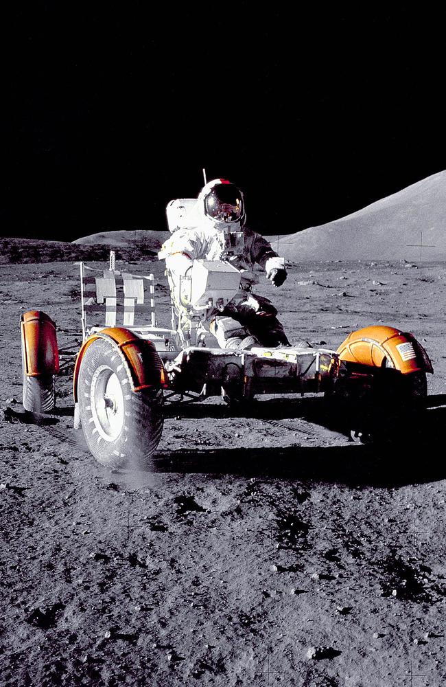 Dust flies from the tyres of a moon buggy driven by Apollo 17 astronaut Gene Cernan.