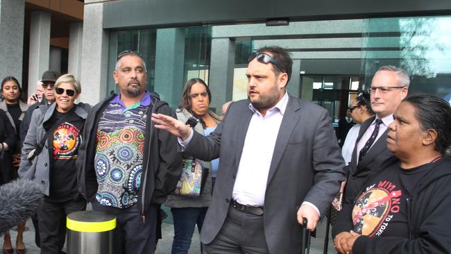 Lawyer, Nick Llewellyn-Jones, fronts the media, alongside Jason Bilney and Jonas Dare, as celebrations begin outside the court. Picture: NCA NewsWire / Dean Martin