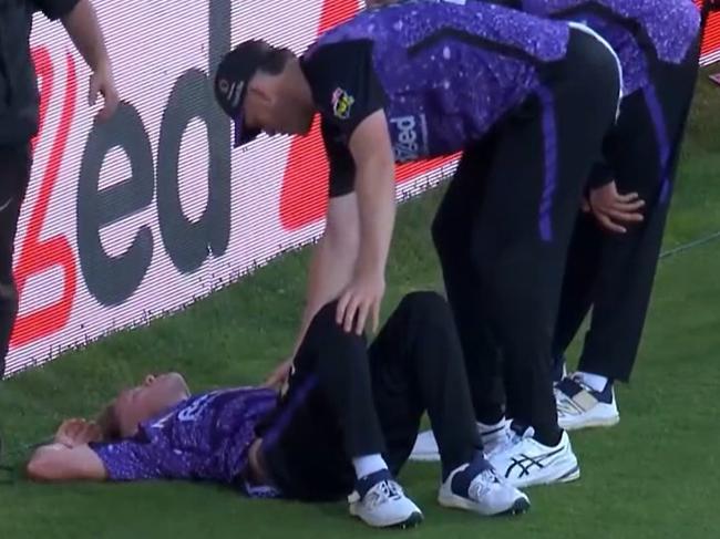 Hurricanes player Nathan Ellis lays prone after colliding head-first with the advertising board.