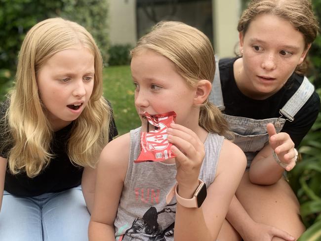 Scarlett O’Connell, 9, keeps an eye on her KitKat chocolates from her 10-year-old sisters Suraya and Lucinda, 12. Picture: Lachlan Miranda