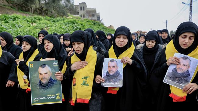 Mourners carry portraits of Ibrahim Raslan, a Hezbollah member who was killed yesterday in southern Lebanon in cross-border fire with Israeli troops, during his funeral in Markaba on December 21, 2023. Picture: AFP