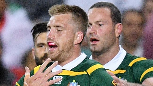 Cameron Munster of Australia (centre) celebrates with teammates.