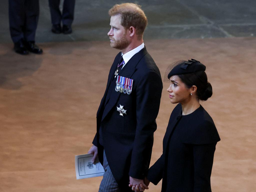 : Prince Harry and Meghan, Duchess of Sussex walk as procession with the coffin of Britain's Queen Elizabeth arrives at Westminster Hall from Buckingham Palace for her lying in state. Picture: Phil Noble - WPA Pool/Getty Images