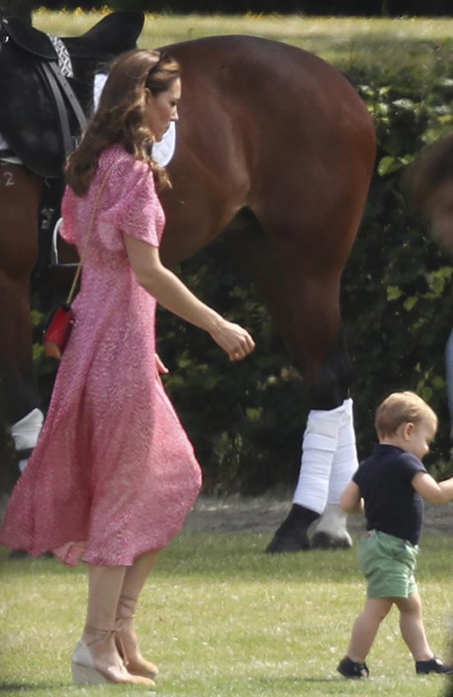 Britain's Kate runs after Louis at the polo. Picture: Andrew Matthews/PA via AP.