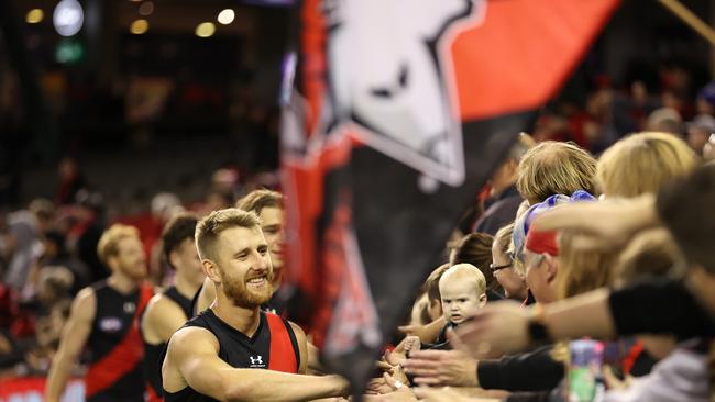 MELBOURNE, AUSTRALIA – MAY 16: Dyson Heppell of the Bombers celebrates with fans after the Bombers defeated the Dockers during the round 9 AFL match between the Essendon Bombers and the Fremantle Dockers at Marvel Stadium on May 16, 2021 in Melbourne, Australia. (Photo by Robert Cianflone/Getty Images)