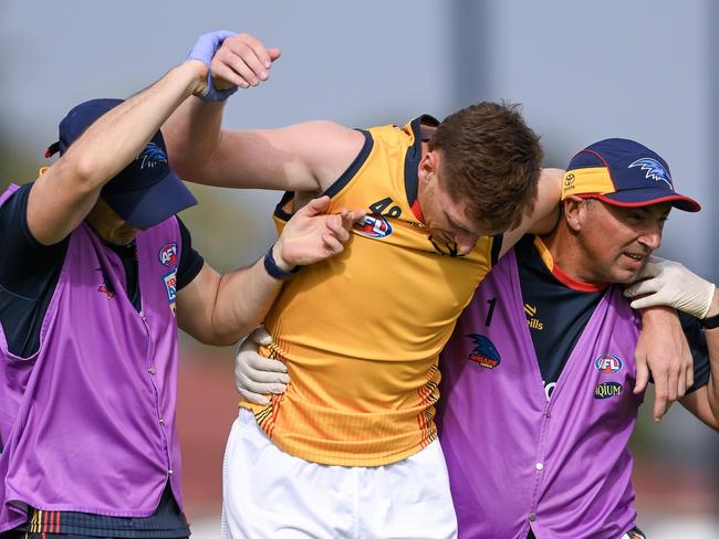 Mark Keane is helped from the field after being concussed in a pre-season game. Picture: Mark Brake/Getty Images