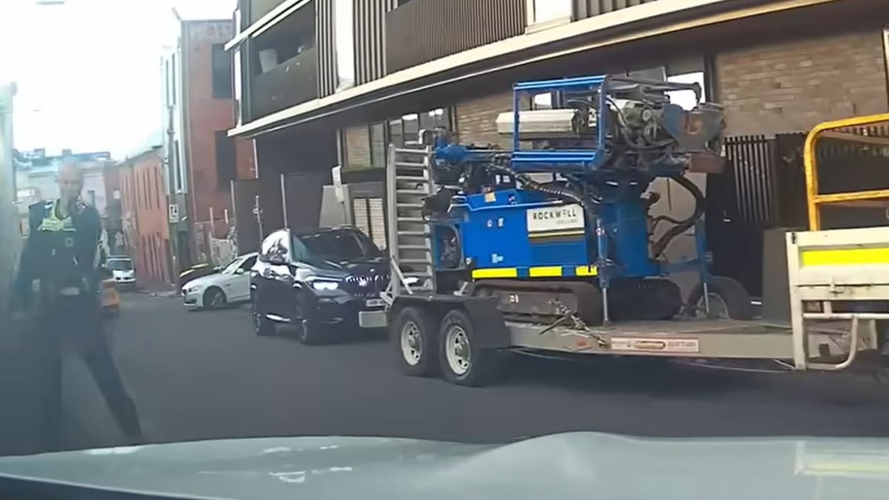 One of the officers is heard shouting for the pair to get out as two draw their weapons, before the woman is heard shouting “go go go”. Picture: Dash Cam Owners Australia Facebook