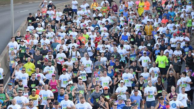 Thousands of people run down Hale Street at the start of the Bridge to Brisbane Fun Run in Brisbane, Sunday, August 27, 2017. The fun run held over a 10 kilometre course has been held annually for 21 years and is Queensland's largest fun run. (AAP Image/Darren England) NO ARCHIVING