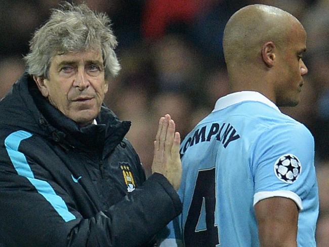 Manchester City's Chilean manager Manuel Pellegrini (L) consoles Manchester City's Belgian defender Vincent Kompany as he leaves the pitch injured during a UEFA Champions League last 16, second leg football match between Manchester City and Dynamo Kiev at the Etihad Stadium in Manchester, north west England, on March 15, 2016. / AFP PHOTO / OLI SCARFF