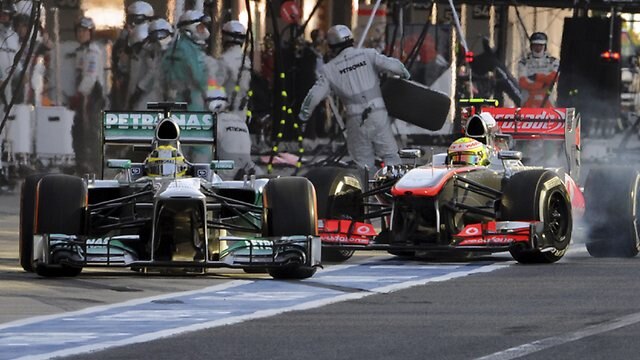 Nico Rosberg drives out of the pits in front of Sergio Perez.