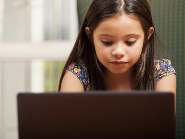 Little girl doing some homework  Child, Laptop, Computer, Childhood, Social Networking Photo: iStock