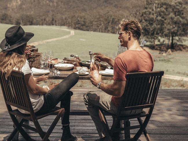 A couple dine at the NSW luxury resort in Wolgan Valley.