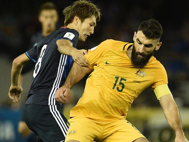 Genki Haraguchi tries to get past Mile Jedinak in Melbourne last year,