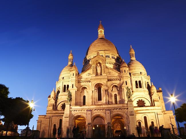 Scare Coeur de Monmartre at night — one of the 21 things to do in Paris, according to Lonely Planet.