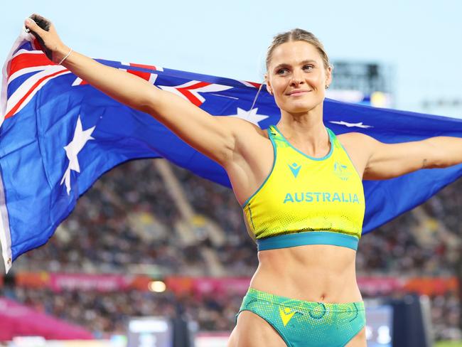 BIRMINGHAM, ENGLAND - AUGUST 02: Nina Kennedy of Team Australia celebrates with their countries flag after winning Gold medal in the Women's Pole Vault Final on day five of the Birmingham 2022 Commonwealth Games at Alexander Stadium on August 02, 2022 in the Birmingham, England. (Photo by Michael Steele/Getty Images)