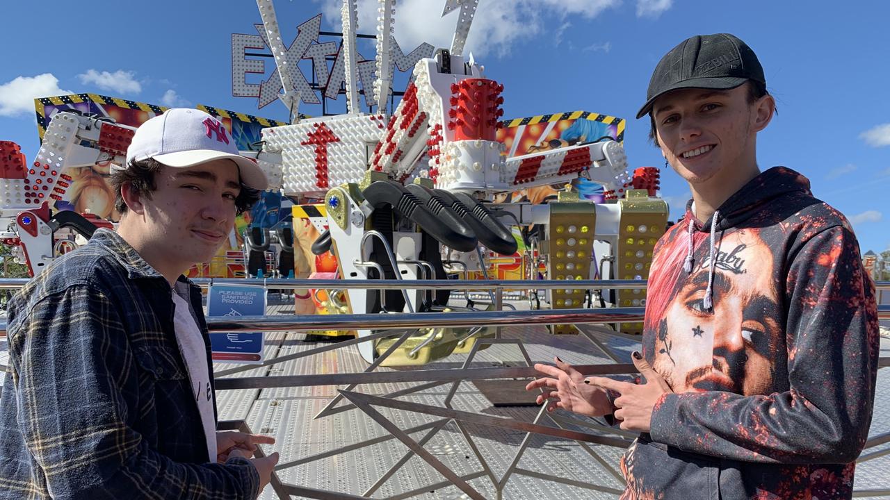 (L) Travis Wason and Jesse Barnell point to the Extreme ride they went on at the Fraser Coast Ag Show.