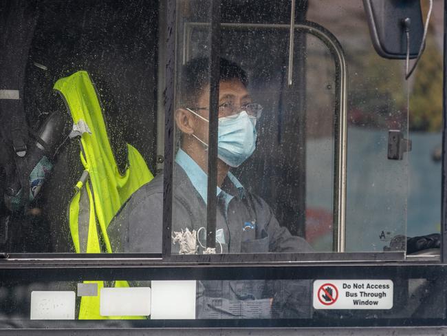 A bus driver wears a face mask while driving a route through Bondi Junction yesterday. Picture: Getty Images