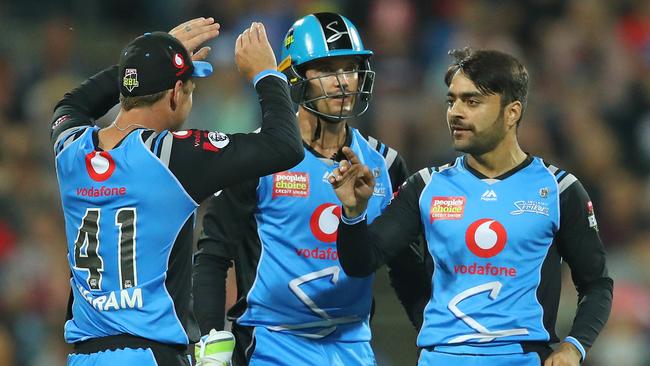 Rashid Khan of the Strikers celebrates a wicket with Colin Ingram and Alex Carey. Picture: Scott Barbour/Getty Images