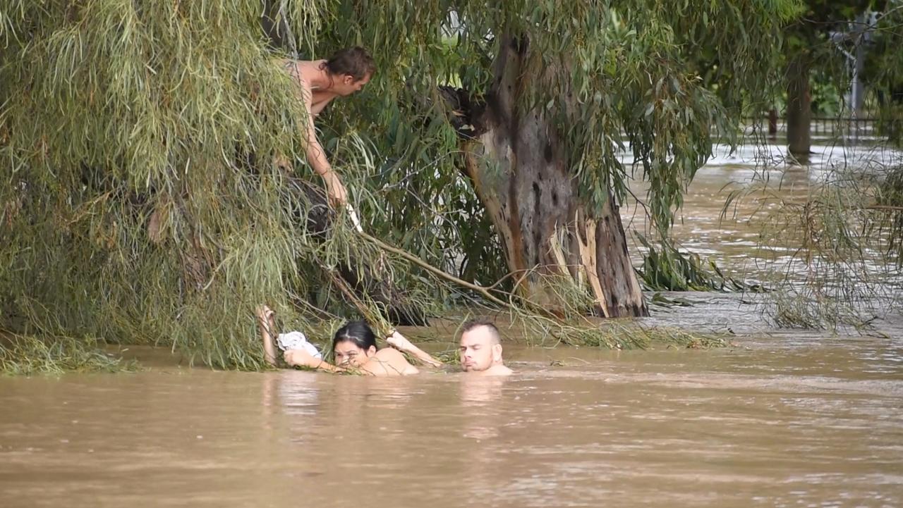 A man and woman stranded in floodwaters in Dalby. Picture: Glenn Hurse/Severe Weather Australia