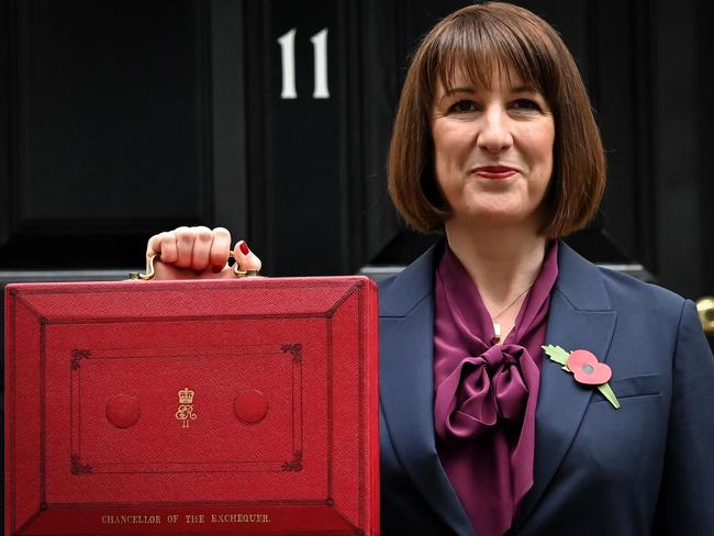 TOPSHOT - Britain's Chancellor of the Exchequer Rachel Reeves poses with the red Budget Box as she leaves 11 Downing Street, in central London, on October 30, 2024, to present the government's annual Autumn budget to Parliament. Britain's new Labour government unveils its first budget on Wednesday, the highly-anticipated fiscal update, the first under the centre-left government after 14 years of Conservative rule. (Photo by Justin TALLIS / AFP)