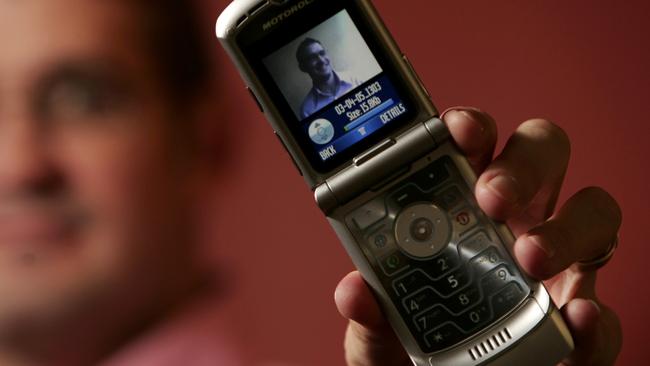 Chief phone designer Jim Wicks holds one of Motorola's 2005 Razr cell phone at the company's design centre in Chicago.