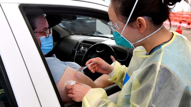 A resident receives a dose of the Pfizer Covid-19 vaccine in Australia’s first drive-through vaccination centre.