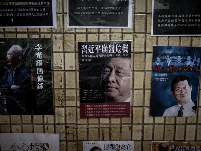 In this photograph taken on January 4, 2016 posters of books about China's politics including some featuring Chinese President Xi Jinping are displayed in the staircase leading to a bookshop in Hong Kong. (AFP/Philippe Lopez)