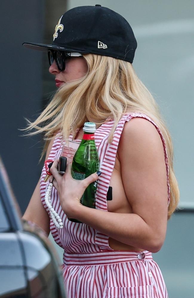 Addison Rae wears a very revealing candy stripe pinafore during a car wash date in Los Angeles. Picture: Backgrid