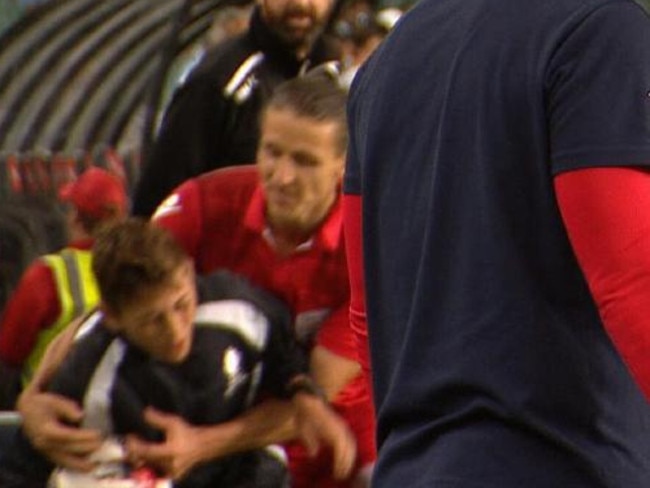 Michael Marrone tackles a ball boy in the Cup final