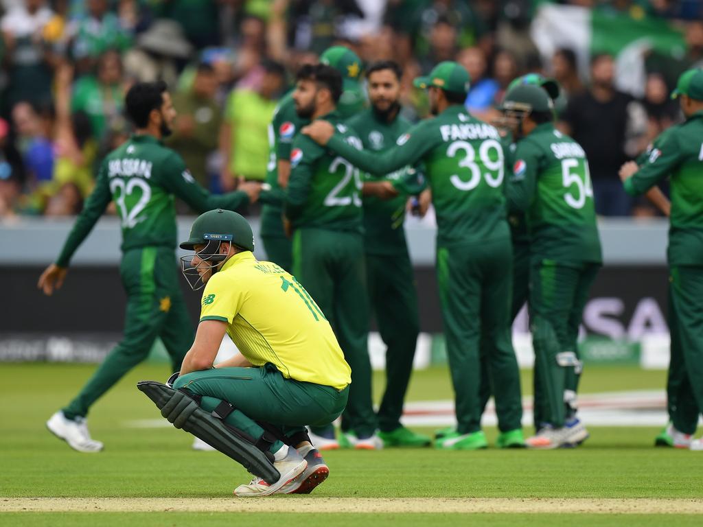 David Miller of South Africa is on his haunches as Pakistan players celebrate another wicket. Picture: Mike Hewitt/Getty Images