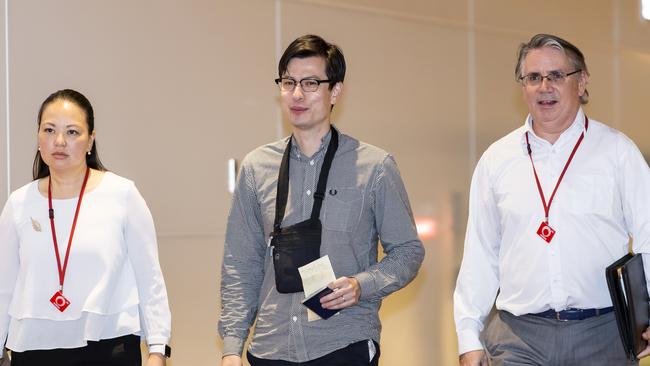 Alek Sigley, centre, walks through the terminal building as he arrives at Haneda Airport in Tokyo, to be reunited with his wife. Picture: AP