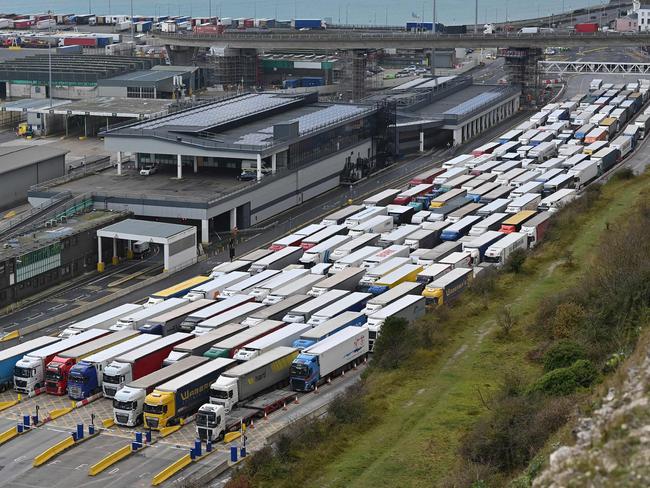 Freight lorries are seen queueing as they wait to enter the port of Dover on the south coast of England on December 10, 2020, before boarding a ferry to Europe. - Big queues of lorries snaked into the port of Dover on England's south coast for another day with high volumes of freight traffic and disruption at other cargo ports put down to Brexit stockpiling, pre-Christmas build up and transport of medical supplies for Covid care increasing demand. If Britain leaves the EU single market on December 31, 2020, without a follow-on trade agreement, the damage caused by delays to travellers and freight at its borders will be compounded by import tariffs. (Photo by JUSTIN TALLIS / AFP)