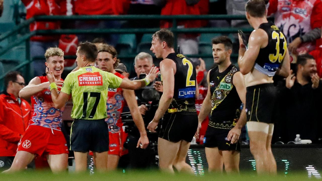 Richmond players appeal to field umpire John Howorth for a controversial 50m penalty after the siren, which was not awarded. Picture: Dylan Burns/AFL Photos via Getty Images