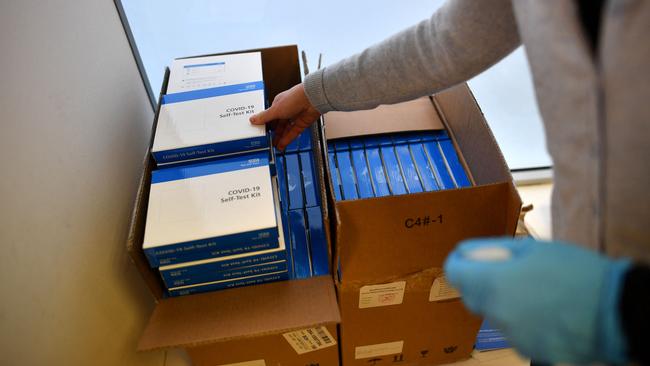 Boxes of Covid-19 lateral flow test kits are received at a school in London.