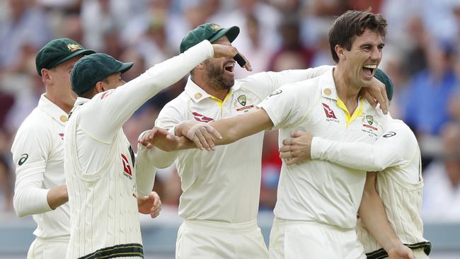 Australia's Pat Cummins, right celebrates with teammates after taking the wicket of England's Joe Root. Picture: AP