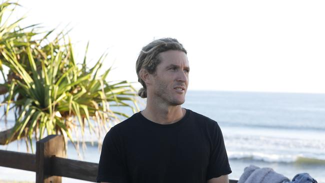 Parkway Drive drummer and local business owner Ben Gordon at Byron Bay before the paddle out in protest against Netflix's planned Byron Baes reality show, at Main Beach on the morning of Tuesday, April 20, 2021. Picture: Liana Boss