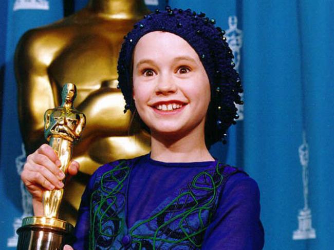 An adorable 11-year-old Anna Paquin with her Oscar, which she won for her role in the film The Piano.