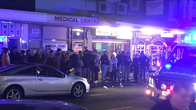 Onlookers at the scene of the incident on Hindley St on Friday night. Picture: Mitch Mott