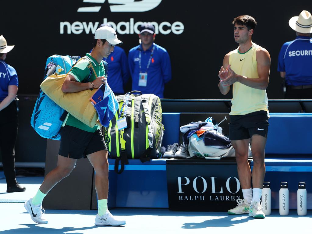 Carlos Alcaraz (right) applauds as an injured Shang Juncheng leaves Rod Laver Arena. Picture: Mark Stewart