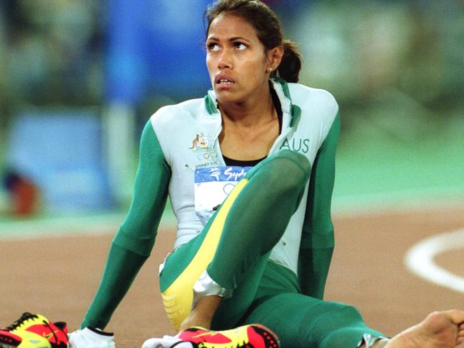 Athletics - Aust athlete Cathy Freeman sitting on track after winning womens 400m final race at Sydney Olympic Games 25 Sep 2000.