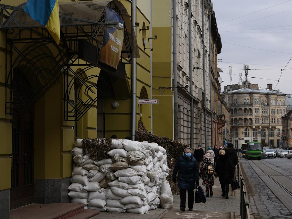 Sand bags propped up against building shopfronts offer little protection from Russian missiles. Picture: Dan Kitwood