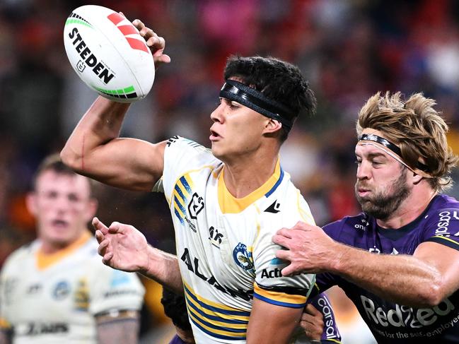 BRISBANE, AUSTRALIA - MAY 19: Blaize Talagi of the Eels passes as he is tackledduring the round 11 NRL match between Melbourne Storm and Parramatta Eels at Suncorp Stadium, on May 19, 2024, in Brisbane, Australia. (Photo by Bradley Kanaris/Getty Images)