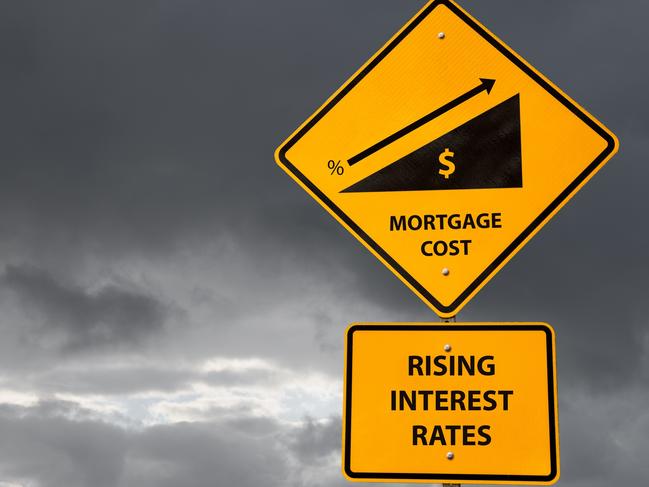 Conceptual sign about rising mortgage costs due to higher interest rates with storm sky in background. Business and finance concept. home loans generic