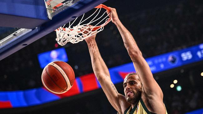 Australia's Xavier Cooks dunks the ball during the FIBA Basketball World Cup group F match between Australia and Japan at Okinawa Arena in Okinawa on August 29, 2023. (Photo by Yuichi YAMAZAKI / AFP)