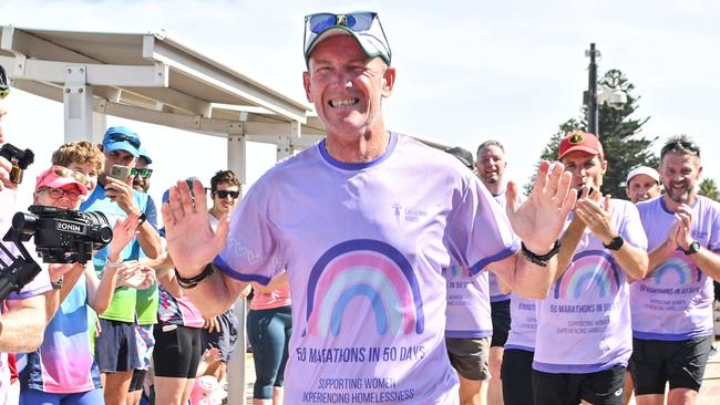 JANUARY 11, 2025: Asa Cowell finishes running his 50th marathon in 50 days at Seacliff raising money for Catherine House. Picture: Brenton Edwards