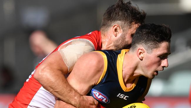 Chayce Jones of the Crows is tackled by Sam Gray of the Swans during the Round 1 AFL match between Adelaide Crows and Sydney Swans at Adelaide Oval in Adelaide, Saturday, March 21, 2020. (AAP Image/David Marauz) NO ARCHIVING, EDITORIAL USE ONLY