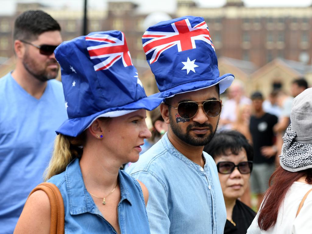 People wearing Australian flag hats watch the Ferrython race on Sydney Harbour during Australia Day celebrations in in Sydney. Picture: AAP Image/Brendan Esposito