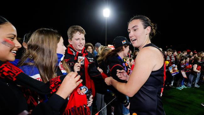 Bombers captain Bonnie Toogood signs autographs with some of the fans that hung around. (Photo by Dylan Burns/AFL Photos via Getty Images)