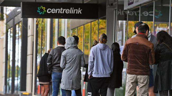 People thrown out of work by the pandemic queue outside a Centrelink office. Picture: AFP